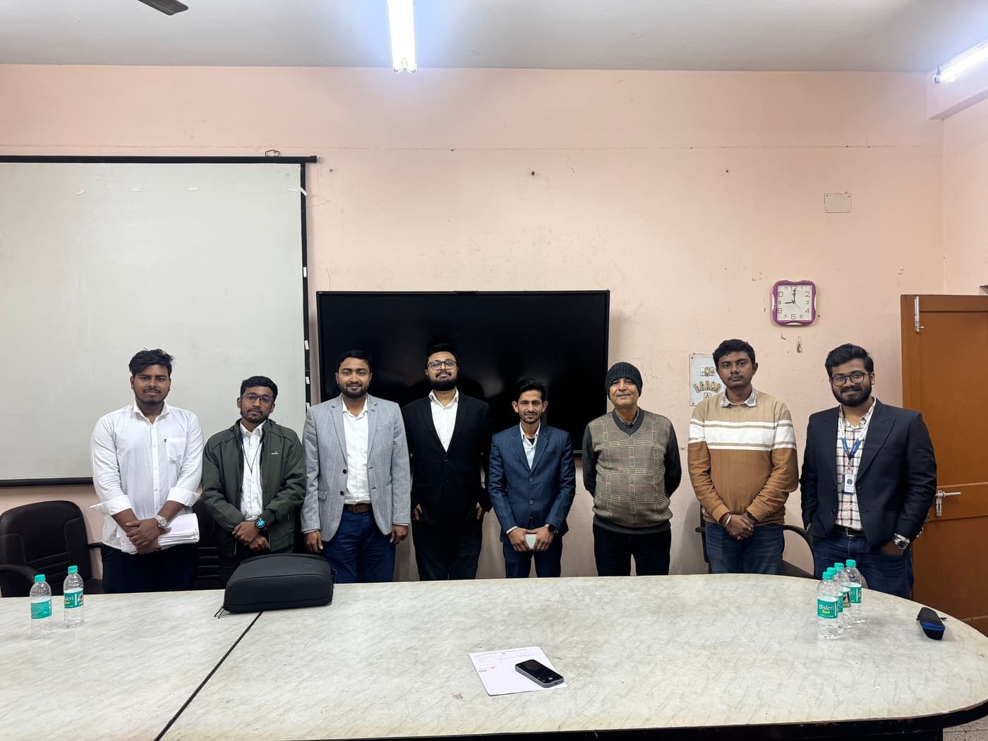 Techimpace interview panel standing with college faculty in a seminar room at the Kolaghat campus drive